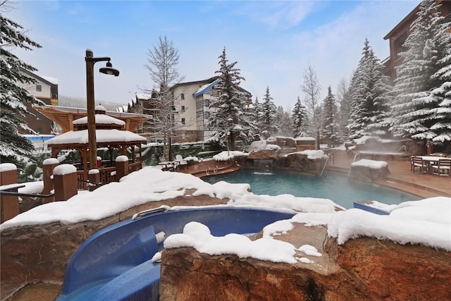 snow covered pool with an outdoor pool and a gazebo