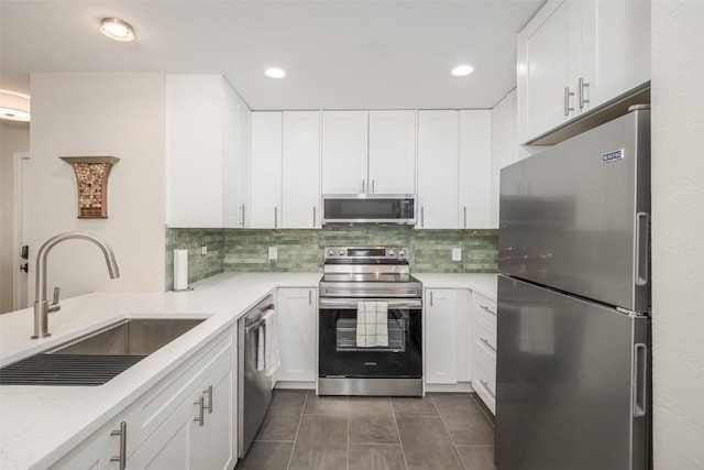 1458 Morgan Ct Unit 1603, Steamboat Springs, CO 80487 - kitchen with appliances with stainless steel finishes, tasteful backsplash, white cabinets, and recessed lighting