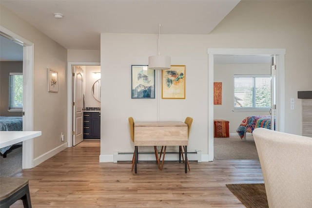 1458 Morgan Ct Unit 1603, Steamboat Springs, CO 80487 - dining area with a baseboard radiator, light wood-style floors, and plenty of natural light
