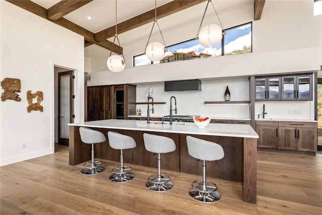 18 Heather Way, Silverthorne, CO 80498 - kitchen with a high ceiling, beam ceiling, a sink, light countertops, and open shelves