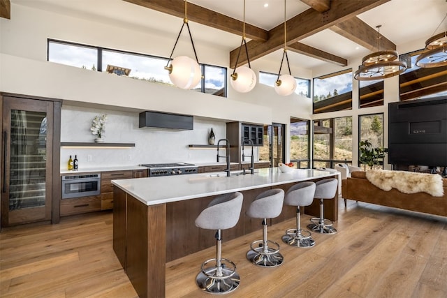 18 Heather Way, Silverthorne, CO 80498 - kitchen featuring open shelves, a high ceiling, a sink, plenty of natural light, and ventilation hood