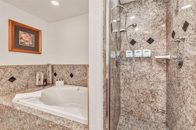 bathroom with a bath and a stall shower