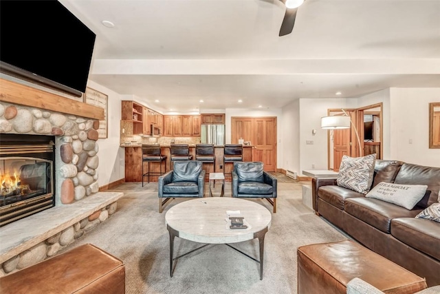 living area with baseboards, light carpet, a fireplace, and recessed lighting