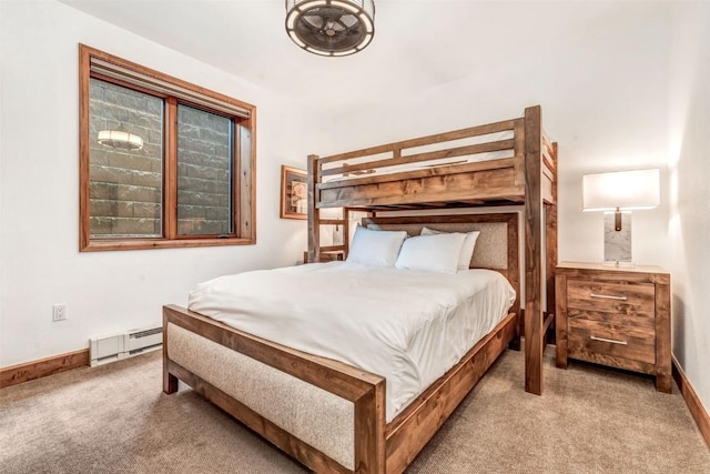 bedroom with a baseboard heating unit, carpet flooring, and baseboards