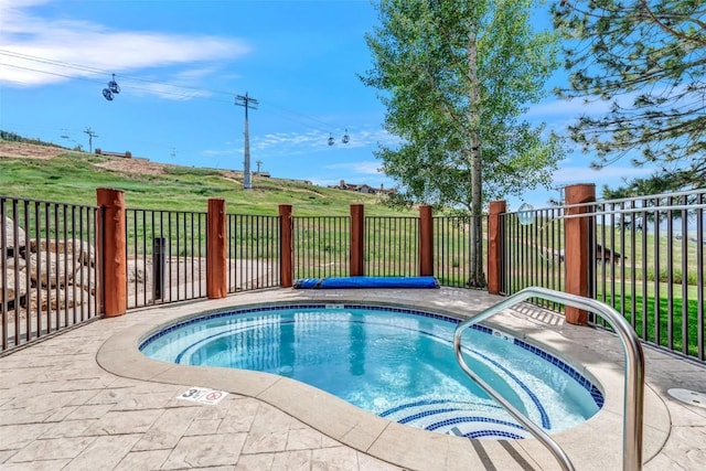 view of pool featuring fence