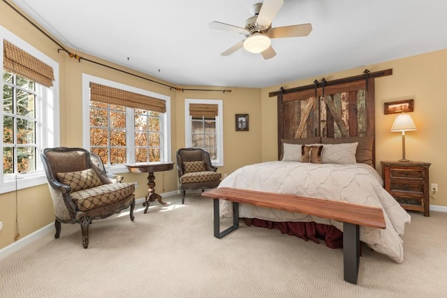 1031 Steamboat Blvd, Steamboat Springs, CO 80487 - carpeted bedroom featuring a barn door and ceiling fan