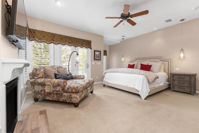 1031 Steamboat Blvd, Steamboat Springs, CO 80487 - bedroom featuring access to exterior, carpet floors, a fireplace with flush hearth, a ceiling fan, and recessed lighting