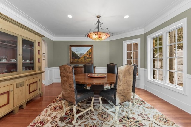 1031 Steamboat Blvd, Steamboat Springs, CO 80487 - dining area with wood finished floors, a wainscoted wall, arched walkways, crown molding, and recessed lighting