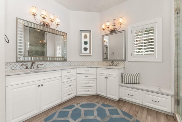 1031 Steamboat Blvd, Steamboat Springs, CO 80487 - bathroom with double vanity, a chandelier, and tasteful backsplash