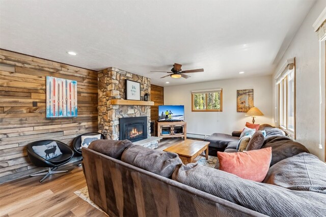 119 Royal Tiger Rd, Breckenridge, CO 80424 - living area with ceiling fan, wood finished floors, a baseboard heating unit, recessed lighting, and a stone fireplace