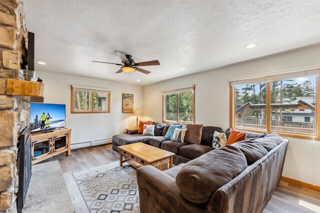 119 Royal Tiger Rd, Breckenridge, CO 80424 - living area with a baseboard heating unit, a ceiling fan, light wood-style flooring, a textured ceiling, and recessed lighting