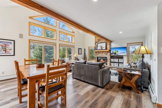 119 Royal Tiger Rd, Breckenridge, CO 80424 - living room featuring a fireplace, a baseboard heating unit, wood finished floors, recessed lighting, and high vaulted ceiling