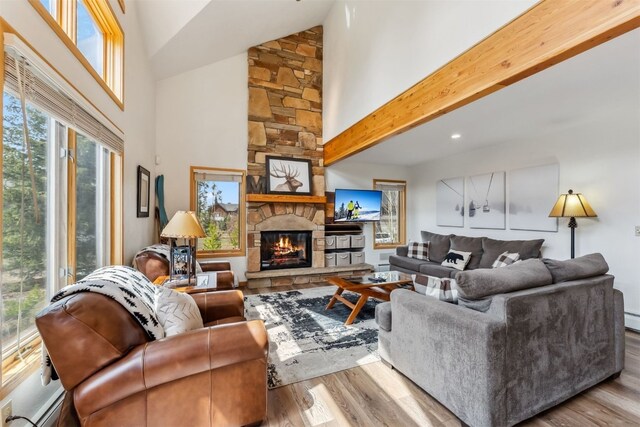 119 Royal Tiger Rd, Breckenridge, CO 80424 - living room featuring wood finished floors, a stone fireplace, high vaulted ceiling, and recessed lighting