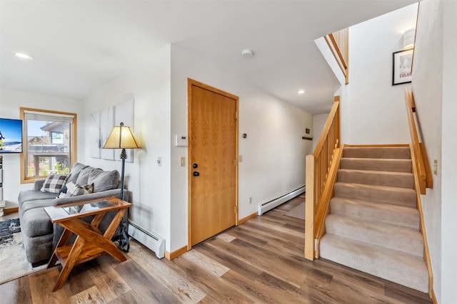 119 Royal Tiger Rd, Breckenridge, CO 80424 - stairway with a baseboard radiator, wood finished floors, recessed lighting, and baseboards