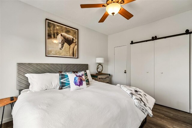1945 Cornice Rd Unit 2224, Steamboat Springs, CO 80487 - bedroom featuring a barn door, wood finished floors, and ceiling fan