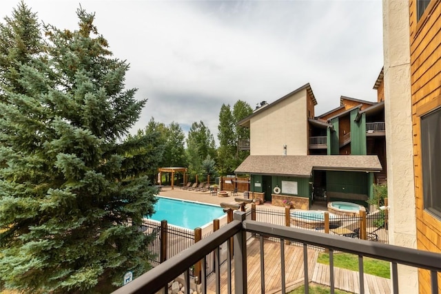 community pool featuring fence and a patio