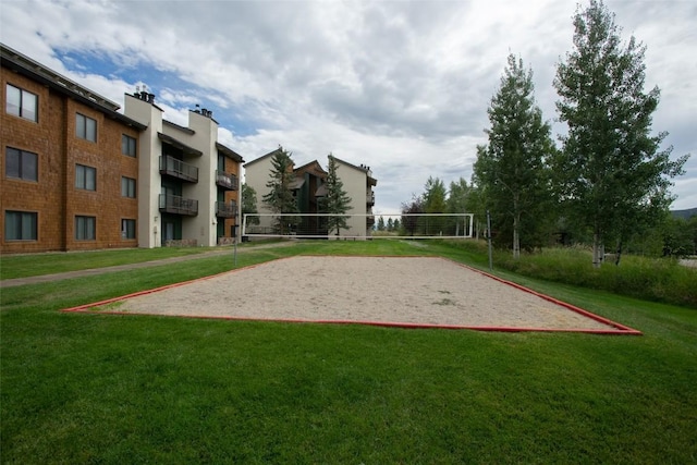 view of home's community with a yard and volleyball court