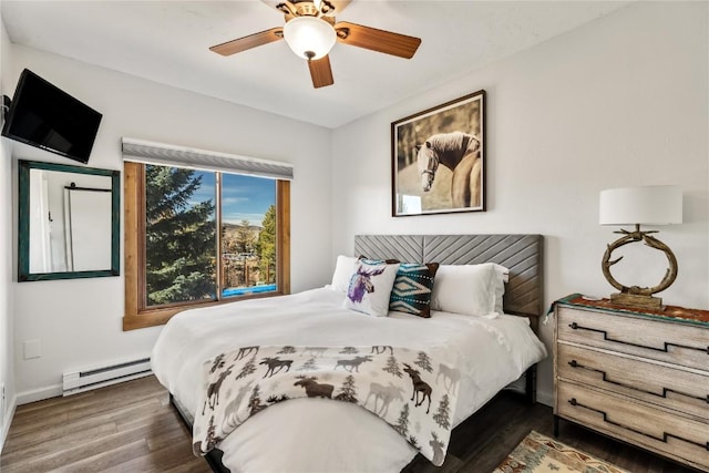 bedroom with baseboard heating, baseboards, a ceiling fan, and wood finished floors