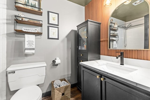 full bathroom with toilet, vanity, wood finished floors, and a shower