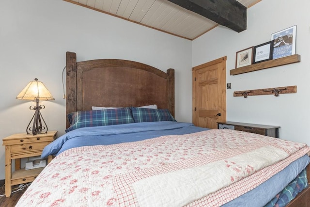 bedroom featuring beamed ceiling, wood finished floors, and wooden ceiling