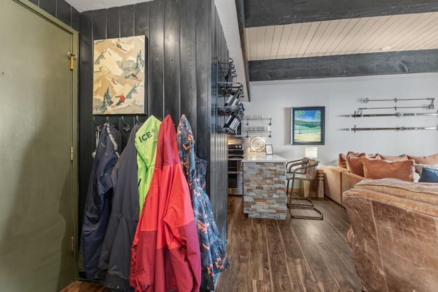 interior space featuring wood finished floors and beam ceiling