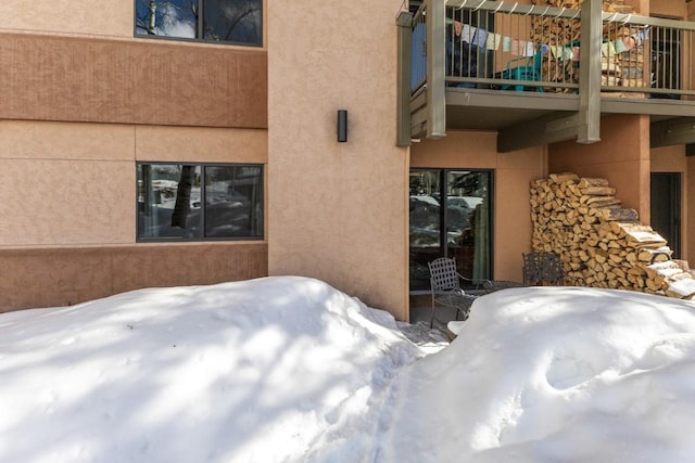 exterior space featuring a patio area, a balcony, and stucco siding