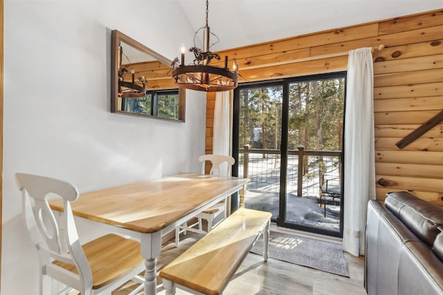1937 Soda Ridge Rd Unit 1146, Keystone, CO 80435 - dining space with light wood-type flooring, log walls, and an inviting chandelier