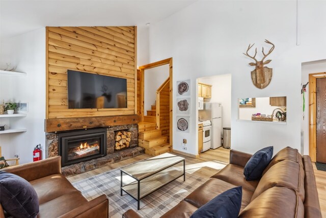 1937 Soda Ridge Rd Unit 1146, Keystone, CO 80435 - living area with stairway, a towering ceiling, light wood-style floors, and a fireplace