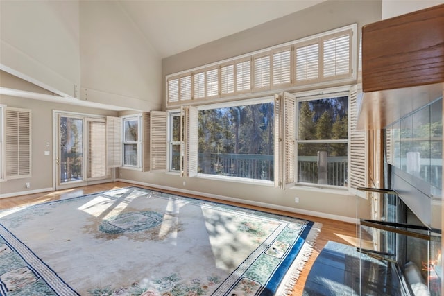 unfurnished sunroom featuring vaulted ceiling