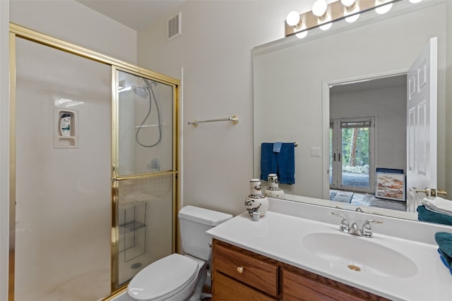 full bathroom with toilet, a stall shower, vanity, and visible vents