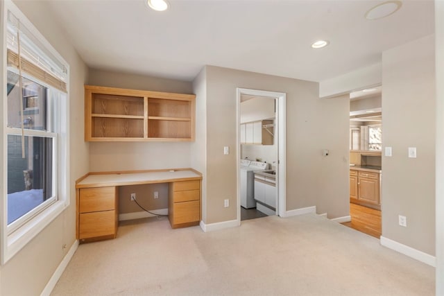 home office featuring recessed lighting, light carpet, built in desk, and baseboards