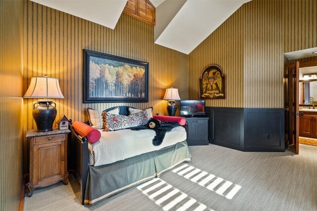 197 Wild Irishman Rd, Keystone, CO 80435 - carpeted bedroom with wallpapered walls, wainscoting, and connected bathroom