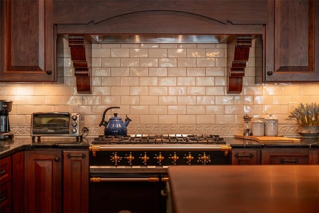 197 Wild Irishman Rd, Keystone, CO 80435 - kitchen featuring decorative backsplash, custom range hood, dark countertops, and stovetop