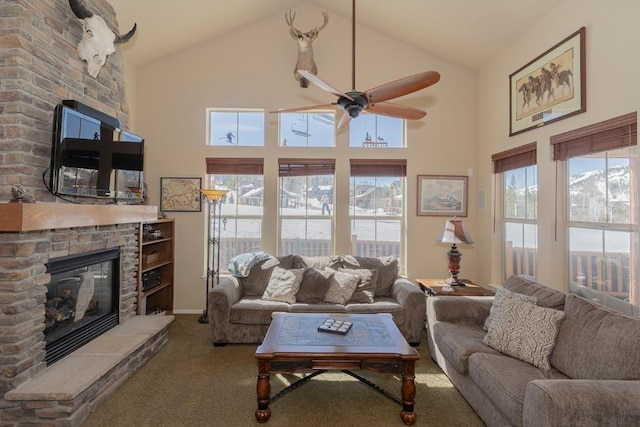 living room with high vaulted ceiling, ceiling fan, carpet flooring, and a fireplace
