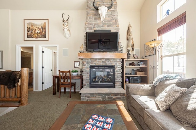 carpeted living room featuring visible vents, a towering ceiling, and a large fireplace