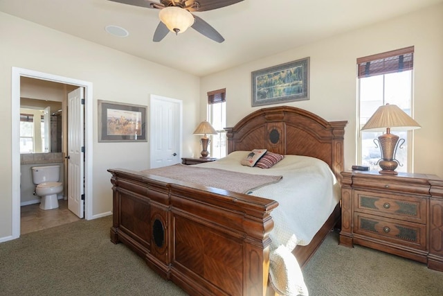 bedroom featuring ensuite bath, light carpet, and multiple windows