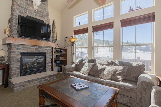carpeted living area featuring a high ceiling and a large fireplace