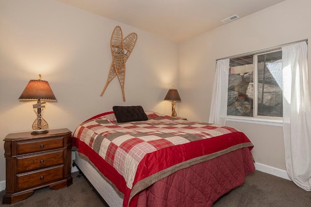 carpeted bedroom featuring baseboards and visible vents
