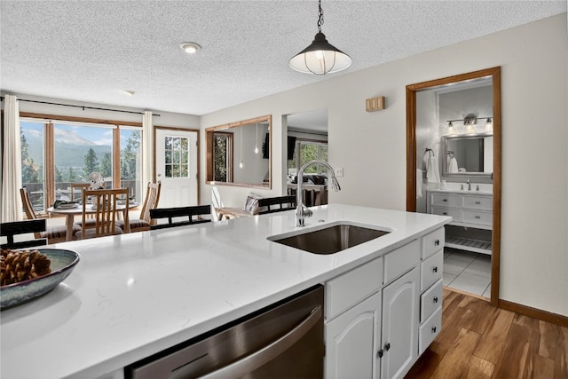 24 Ski Pole Ct, Breckenridge, CO 80424 - kitchen featuring dishwasher, a textured ceiling, light countertops, wood finished floors, and pendant lighting