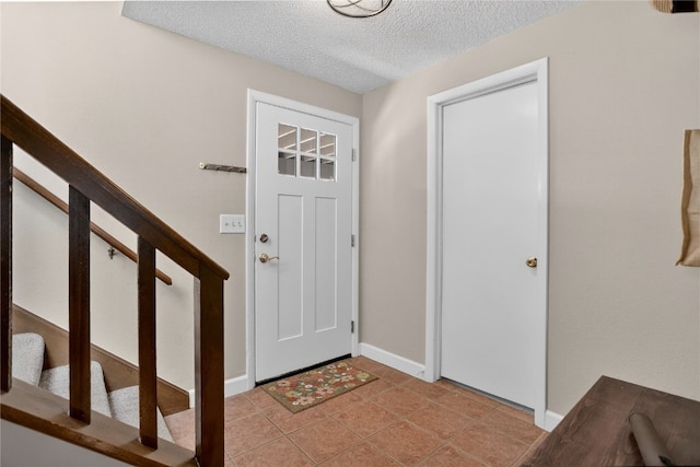 24 Ski Pole Ct, Breckenridge, CO 80424 - foyer featuring a textured ceiling and stairs