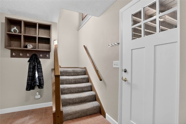24 Ski Pole Ct, Breckenridge, CO 80424 - stairway featuring a textured ceiling and tile patterned flooring