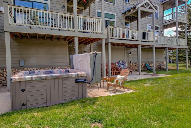102 Creek Ln Unit 102, Silverthorne, CO 80498 - rear view of house featuring a patio, a lawn, a hot tub, and a balcony