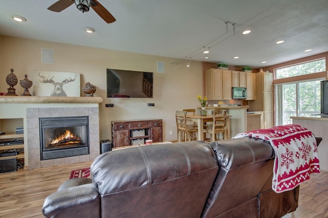 102 Creek Ln Unit 102, Silverthorne, CO 80498 - living area featuring light wood finished floors, recessed lighting, a ceiling fan, and a tiled fireplace