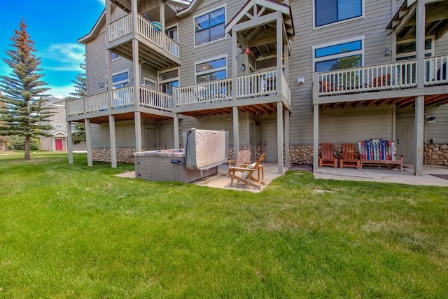 102 Creek Ln Unit 102, Silverthorne, CO 80498 - back of house with a patio area, a lawn, and a hot tub