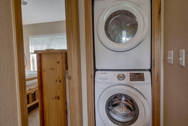 102 Creek Ln Unit 102, Silverthorne, CO 80498 - laundry area with stacked washer / dryer and a textured wall