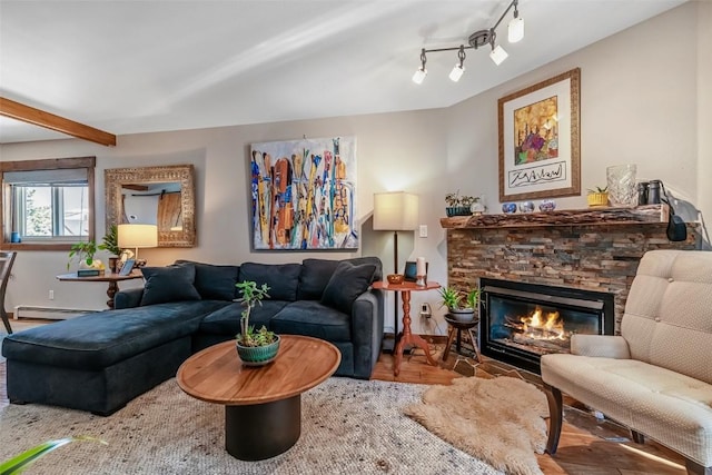living room featuring a baseboard heating unit, a stone fireplace, wood finished floors, and beamed ceiling