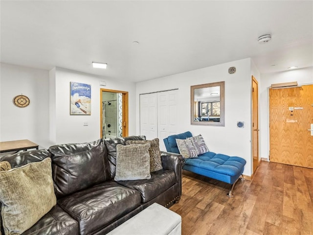living area with wood finished floors and baseboards