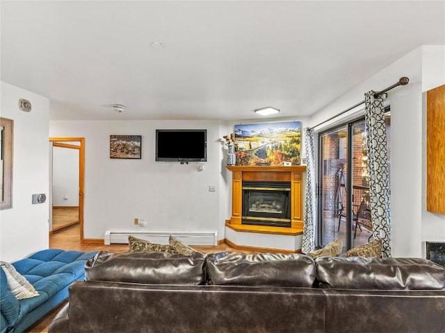 100 S Park Ave Unit E117, Breckenridge, CO 80424 - living room with a baseboard heating unit, a glass covered fireplace, wood finished floors, and baseboards