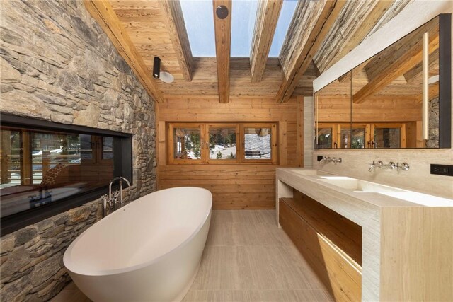 256 Timber Trail Rd, Breckenridge, CO 80424 - bathroom with double vanity, wood ceiling, a freestanding bath, wood walls, and vaulted ceiling with beams