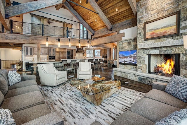 422 Timber Trail Rd, Breckenridge, CO 80424 - living room featuring beam ceiling, wood finished floors, a stone fireplace, high vaulted ceiling, and wood ceiling